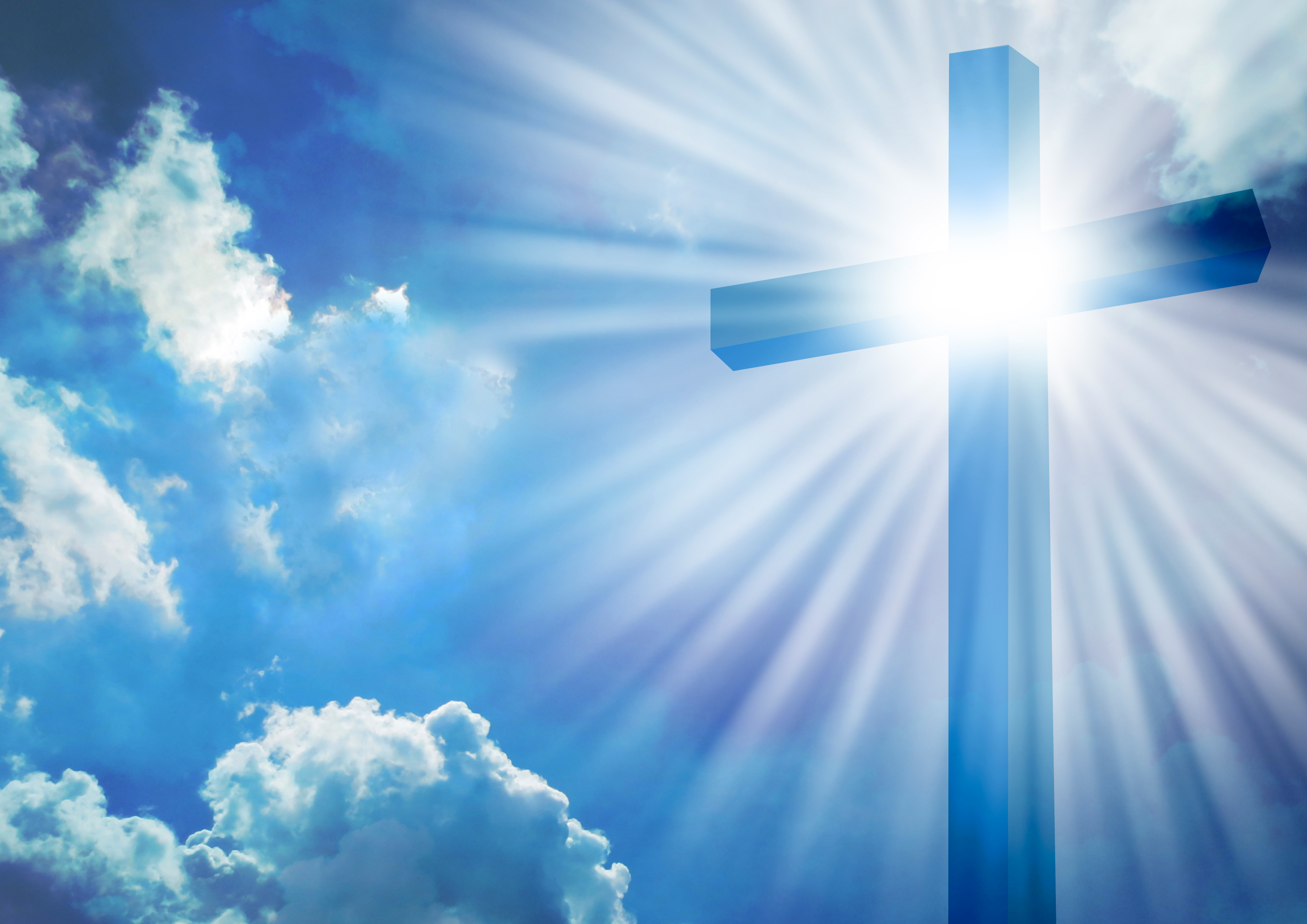 Christian cross with bright sun and clouds background