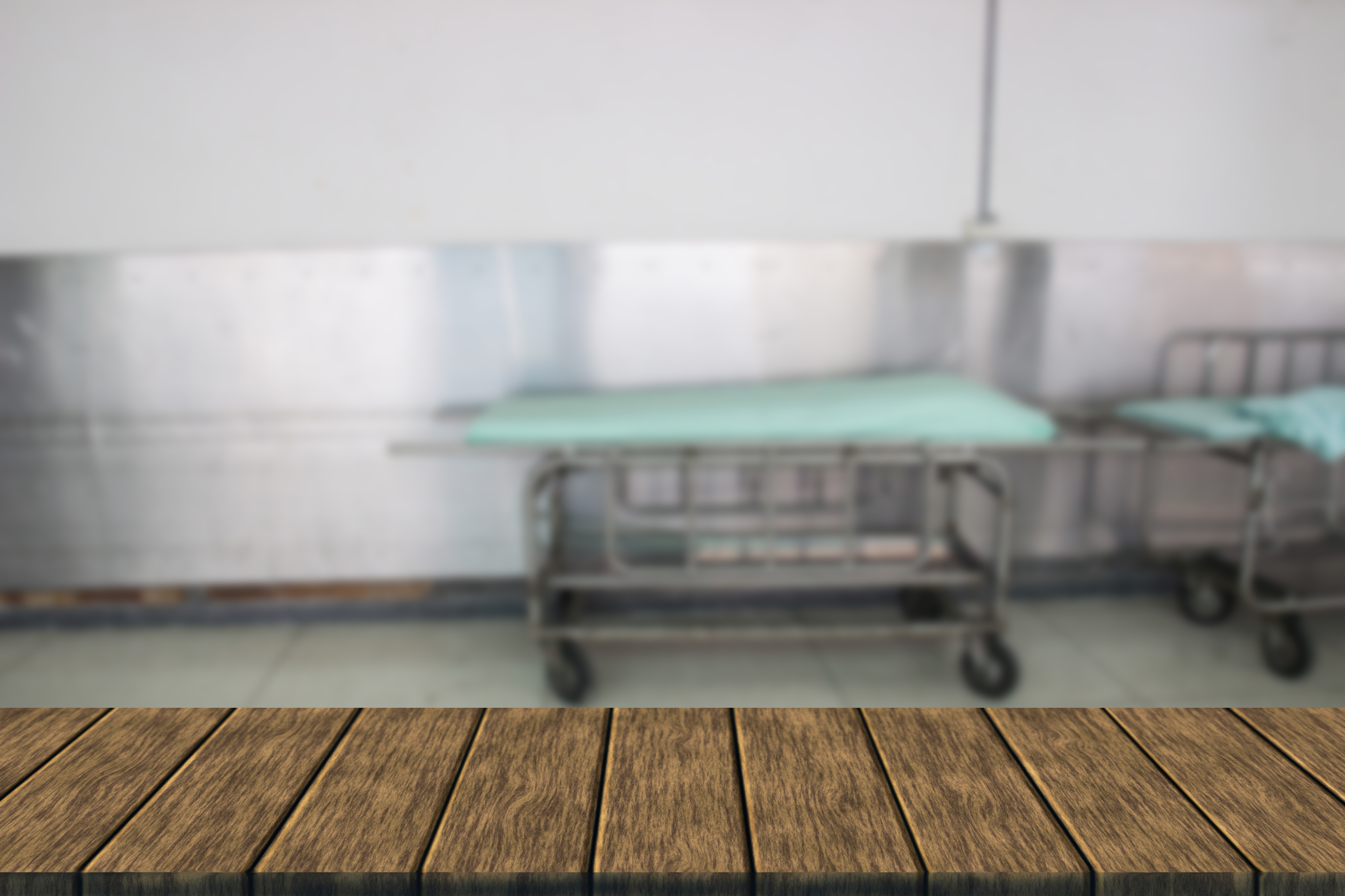 stretcher gurney for patient in hospital (blur background and wooden table for displaying your product)